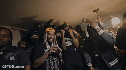 A Group Of Men Wearing Black Shirts With The Letter R On Them Are Dancing GIF