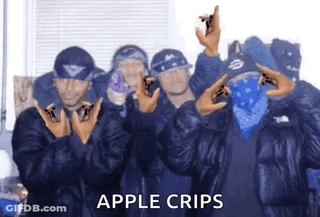 A Group Of Men Wearing Blue Bandanas And Jackets Are Standing Next To Each Other And Making A Peace Sign . GIF