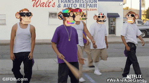 A Group Of Men Wearing Monkey Masks Are Walking Down A Street In Front Of A Walt 'S Auto Repair Store GIF