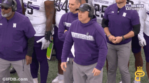 A Group Of Men Wearing Purple Shirts With The Word Northwestern On It GIF