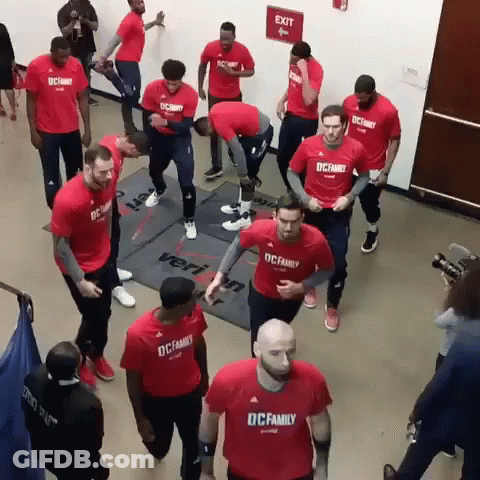 A Group Of Men Wearing Red Shirts That Say Dc Family On Them GIF