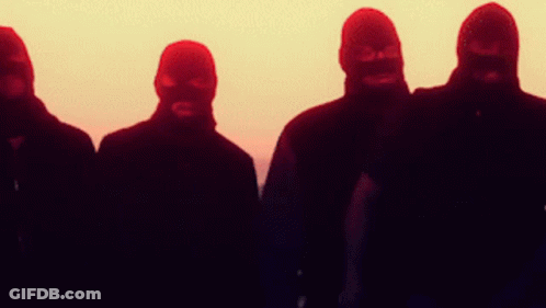 A Group Of Men Wearing Ski Masks Stand In A Row GIF