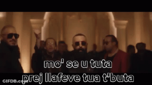 A Group Of Men Wearing Sunglasses And A Beard Are Standing In A Room . GIF