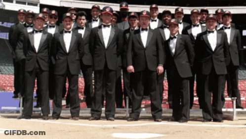 A Group Of Men Wearing Tuxedos And Bow Ties Pose For A Photo GIF