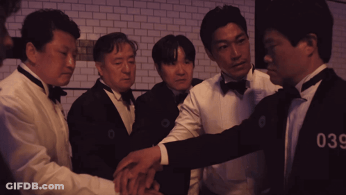 A Group Of Men Wearing Tuxedos And Bow Ties With The Number 036 On Their Chests GIF