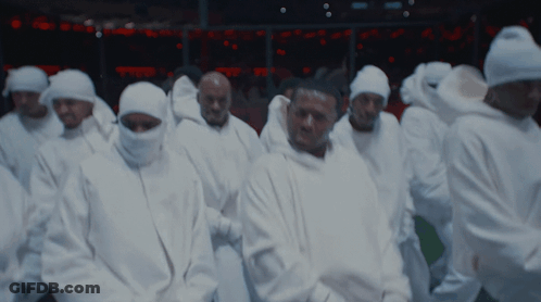 A Group Of Men Wearing White Hoodies With The Letter G On The Front GIF