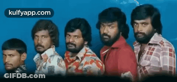 A Group Of Men With Beards Are Standing Next To Each Other In A Line . GIF