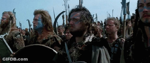 Men With Blue Paint Holding Swords And Shields GIF