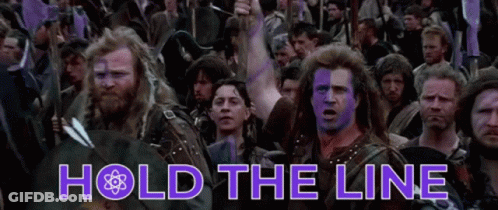 A Group Of Men With Purple Paint On Their Faces Are Standing In A Crowd With The Words Hold The Line Above Them GIF