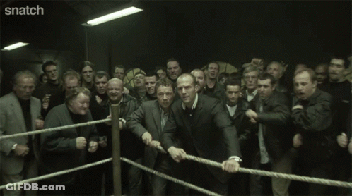 A Group Of Men With Their Eyes Closed And Snatch Written On The Bottom Right GIF