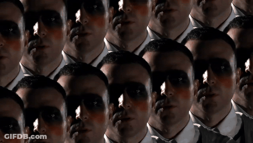 A Group Of Men With Their Faces Painted Black GIF