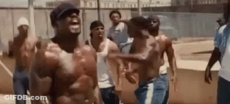 A Group Of Men Without Shirts Are Standing Next To Each Other And Laughing . GIF