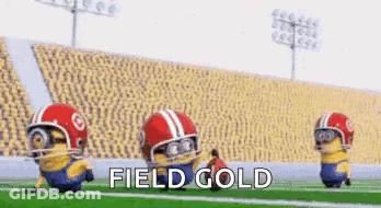 A Group Of Minions Are Playing Football On A Field . GIF