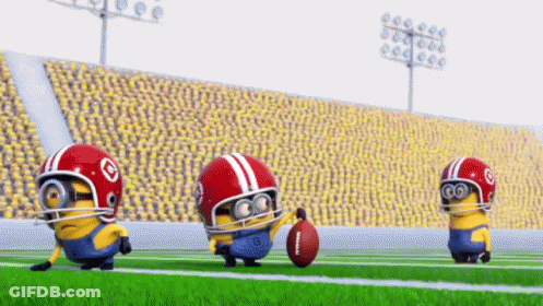 A Group Of Minions Are Playing Football On A Field GIF