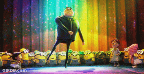 A Group Of Minions Are Standing Around A Stage With A Man Dancing On It GIF