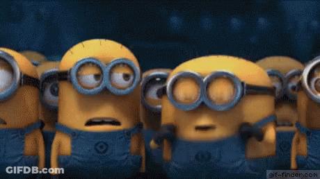 A Group Of Minions Are Standing Next To Each Other With Their Mouths Wide Open . GIF