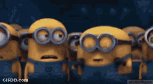 A Group Of Minions Are Standing Next To Each Other With Their Mouths Wide Open . GIF
