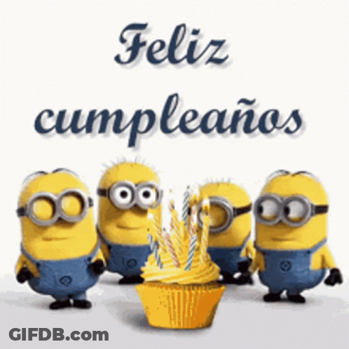A Group Of Minions Standing Around A Cupcake With Candles GIF