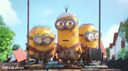 A Group Of Minions Standing On A Wooden Platform GIF