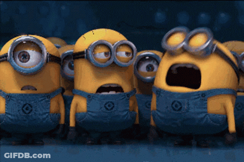 A Group Of Minions Wearing Blue Overalls And Goggles Are Standing Together GIF