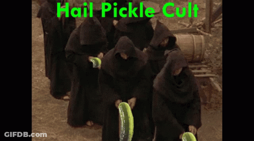 A Group Of Monks Are Holding Pickles In Front Of A Sign That Says " Hail Pickle Cult " GIF