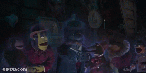 A Group Of Muppets Are Standing In A Dark Room With A Disney+ Logo In The Corner GIF
