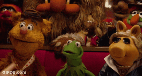 A Group Of Muppets Including Kermit And Miss Piggy Are Sitting Together GIF