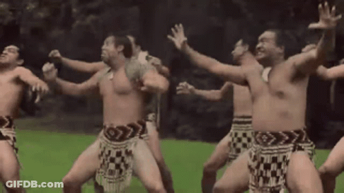 A Group Of Naked Men Are Dancing In A Field GIF