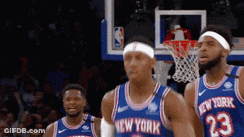A Group Of New York Basketball Players Are Standing In Front Of A Net GIF