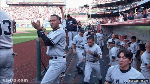A Group Of New York Yankees Baseball Players Standing On The Field GIF