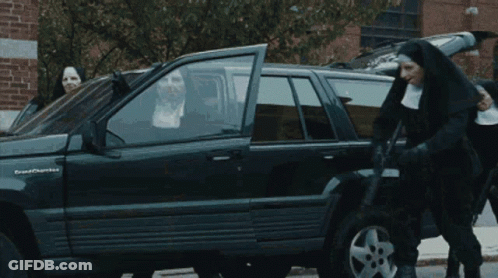A Group Of Nuns Are Standing In Front Of A Black Grand Cherokee GIF