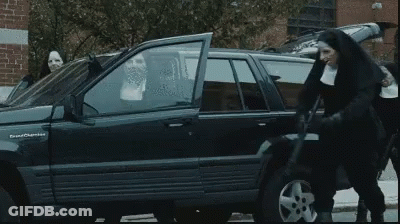 A Group Of Nuns Are Standing In Front Of A Jeep GIF