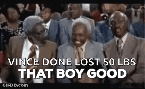 A Group Of Older Men Are Sitting In A Crowd And Laughing . GIF