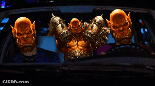 A Group Of Orcs Are Sitting In A Car With A Man In A Suit GIF
