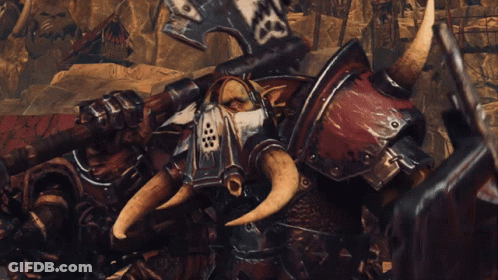 A Group Of Orcs Are Standing In A Desert Holding Weapons And A Shield GIF