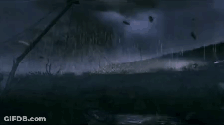A Group Of Parachutes Are Flying In The Sky Over A Field With Telephone Wires . GIF