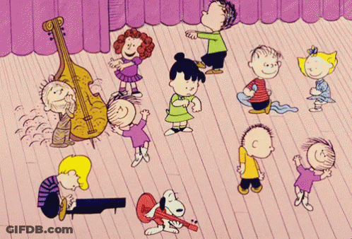 A Group Of Peanuts Characters Are Dancing On A Stage With A Purple Curtain Behind Them GIF