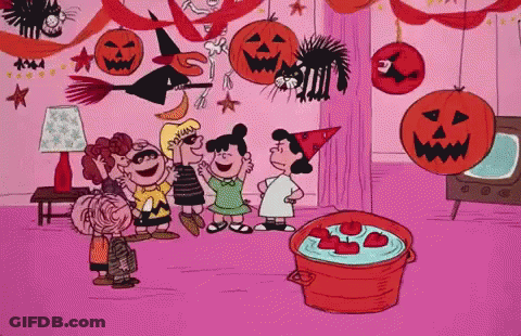 A Group Of Peanuts Characters Are Standing Around A Pot Of Apples GIF