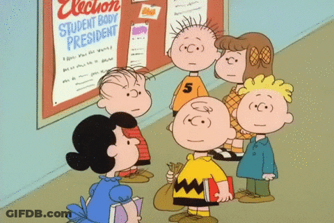 A Group Of Peanuts Characters Are Standing In Front Of A Bulletin Board That Says Election Student Body President GIF