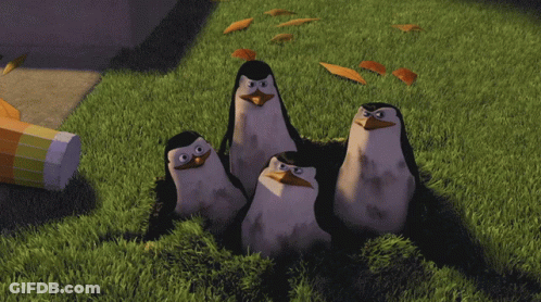 A Group Of Penguins Are Standing In The Grass With The Words Mission Accomplished Written Below Them GIF