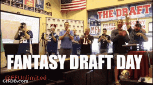 A Group Of People Applauding In Front Of A Sign That Says The Draft Fantasy Draft Day GIF