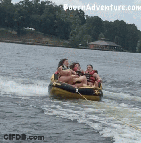 A Group Of People Are Being Towed By A Boat With The Website Tournadventure.com Visible In The Background GIF