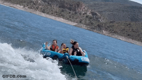 A Group Of People Are Being Towed By A Tube That Says G-Wave GIF
