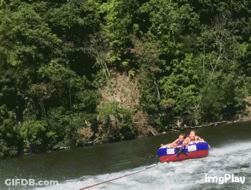 A Group Of People Are Being Towed Down A River By A Boat With Imgplay In The Corner GIF