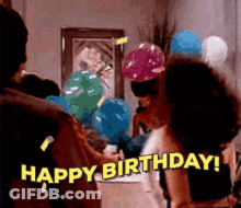 A Group Of People Are Celebrating A Birthday With Balloons And A Woman Is Saying `` Happy Birthday '' . GIF