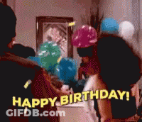 A Group Of People Are Celebrating A Birthday With Balloons And Confetti GIF
