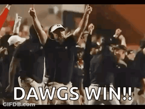 A Group Of People Are Celebrating A Football Game With Their Hands In The Air . GIF