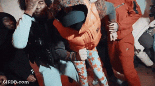 A Group Of People Are Dancing And One Of Them Is Wearing A Vest That Says Nike GIF