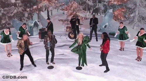 A Group Of People Are Dancing And Singing In The Snow . GIF