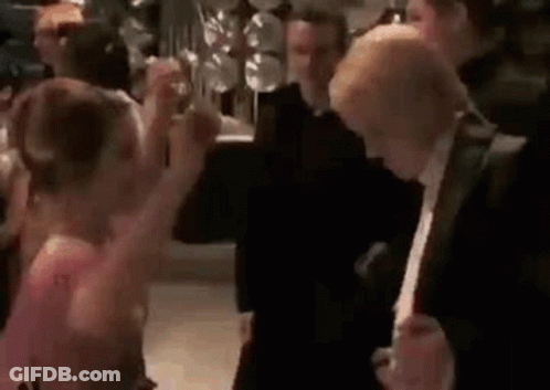 A Group Of People Are Dancing At A Party In A Room . GIF